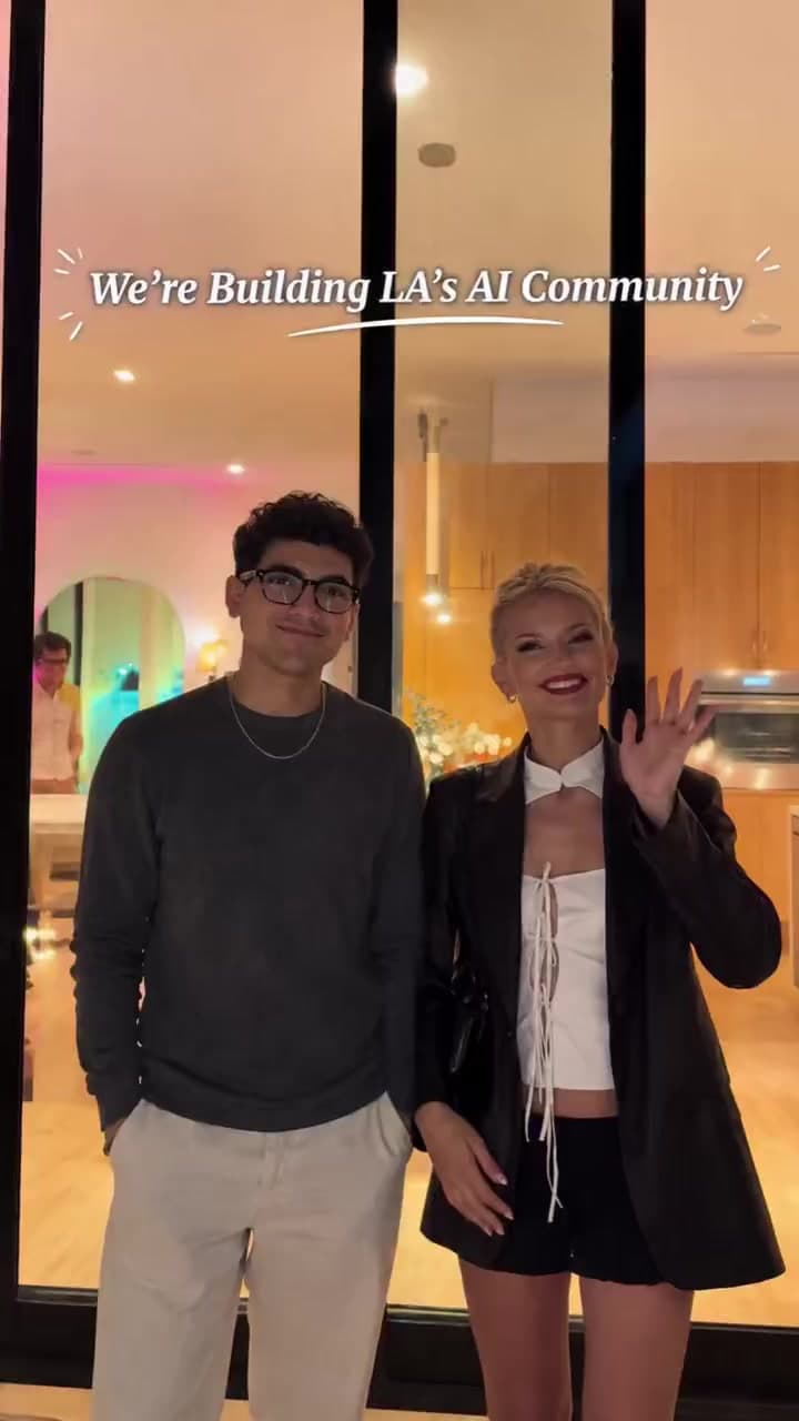 Opening frame of the reel: two members waving by a glass wall at night, captioned “We're Building LA's AI Community”